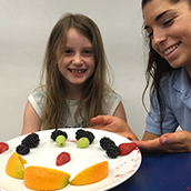 Jade and ashlyn smiling with plate of food 