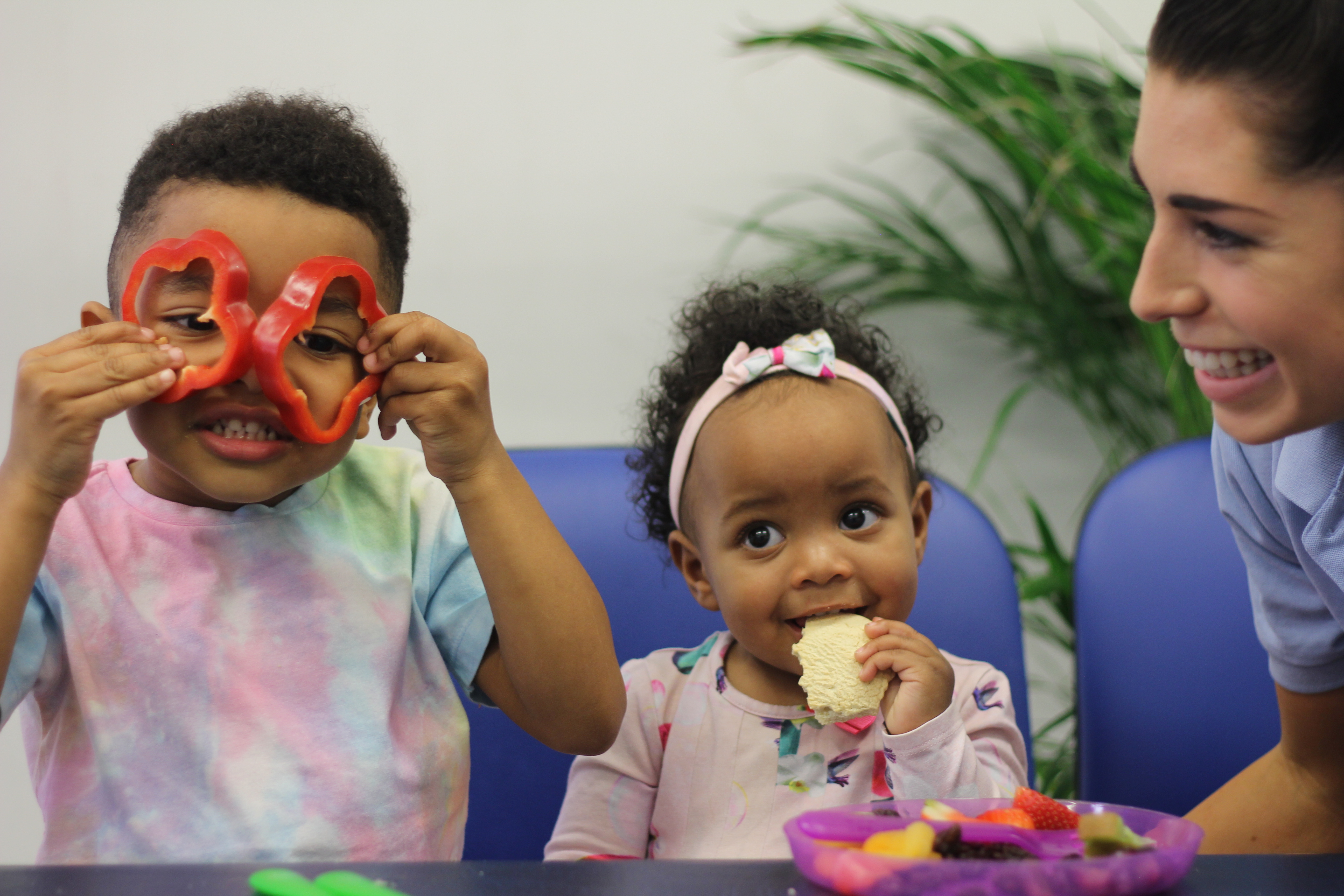 Ezra with peppers as eyes and Jada eating biscuit