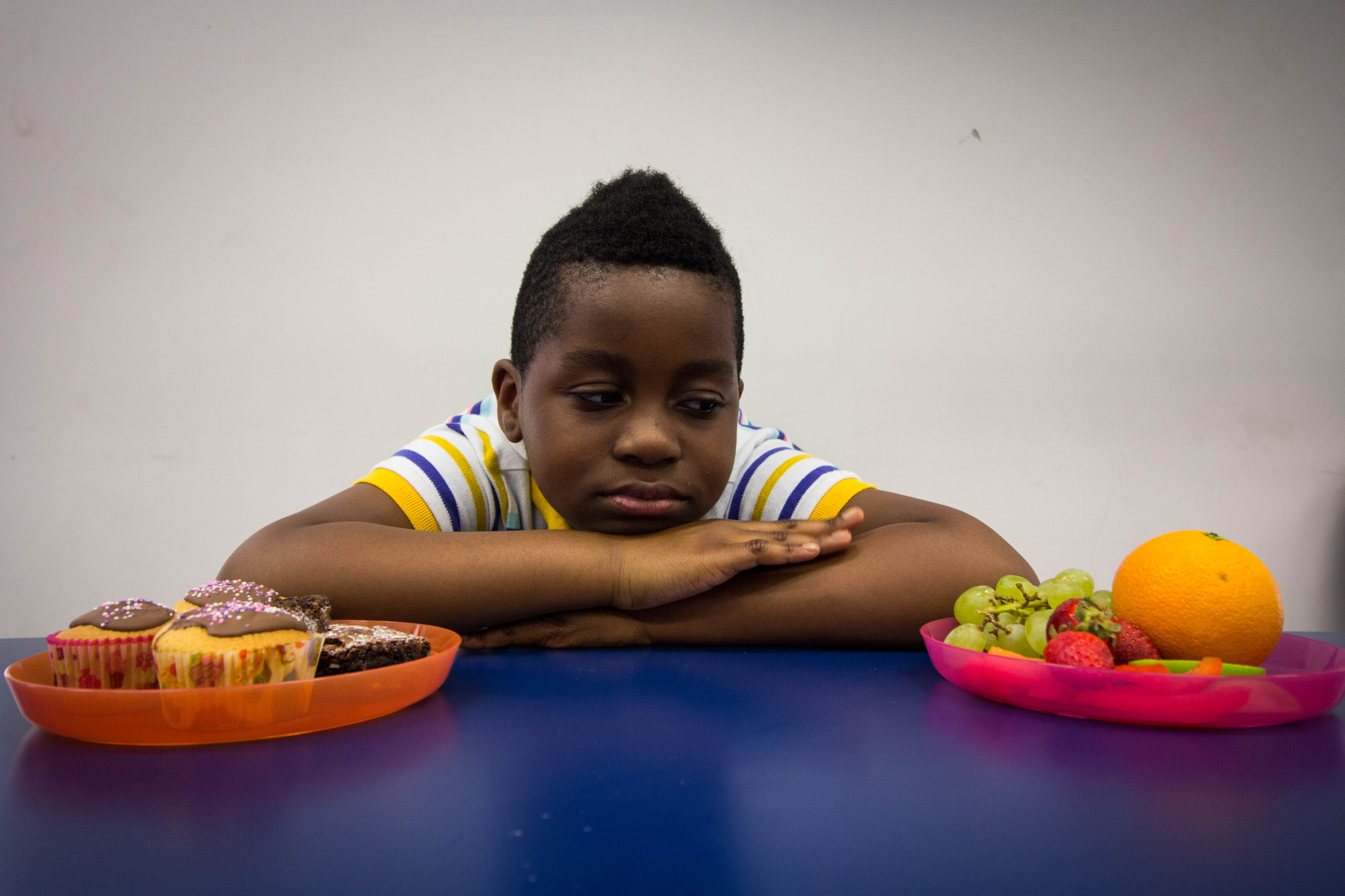 Armel looking glum with two plates of food either side of him