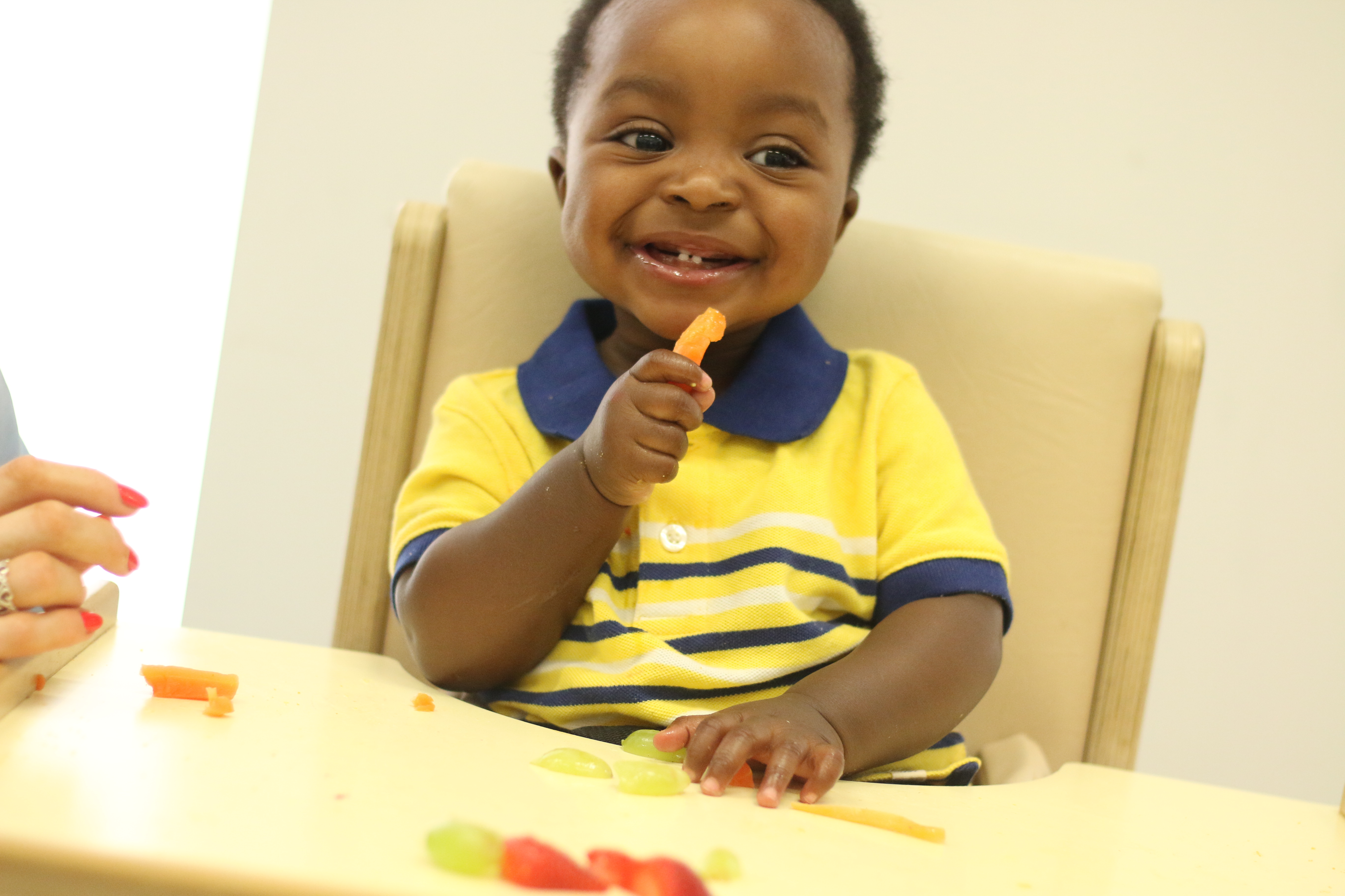 Emery eating crisp smiling/laughing